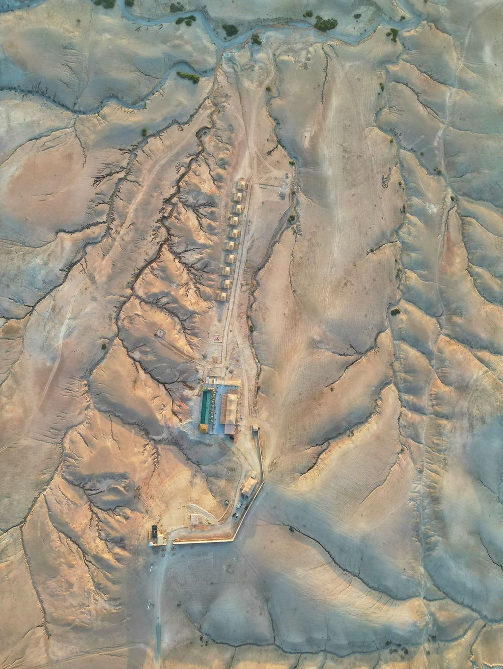 Aerial view of a camp set among the eroded canyons of the Agafay plateau